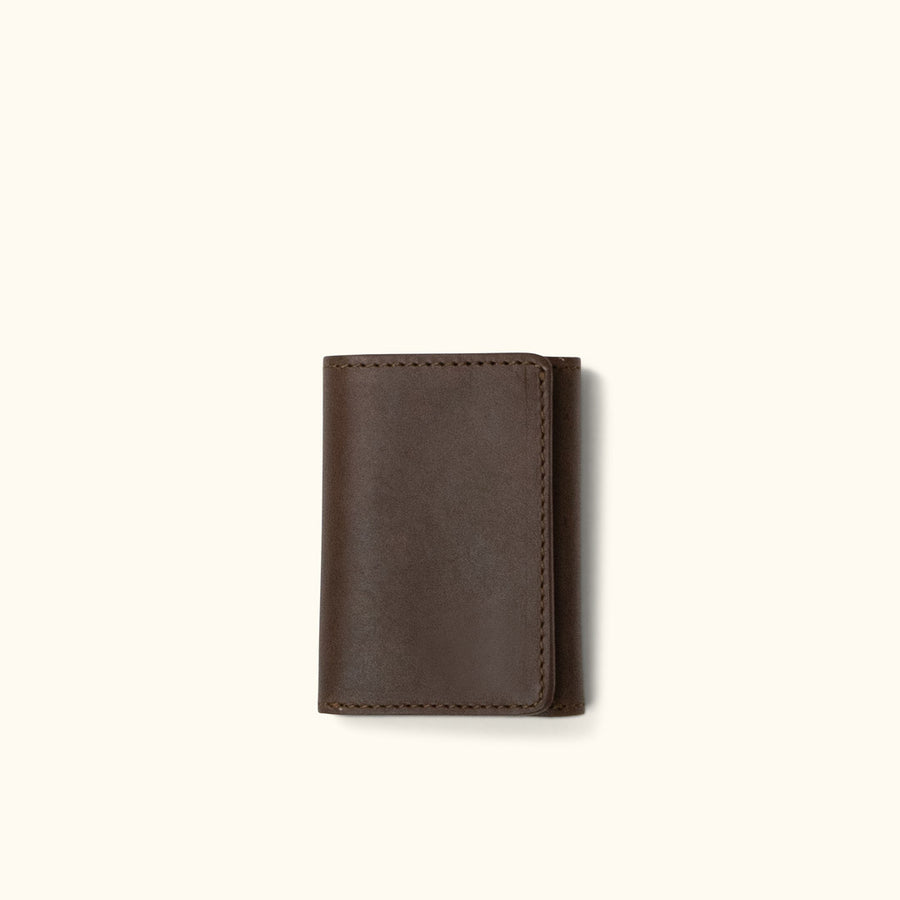Brown leather trifold wallet, featuring a spacious interior with slots for cards and ID.