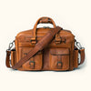 Amber brown Roosevelt buffalo leather pilot bag featuring multiple pockets, adjustable straps, and durable metal hardware.